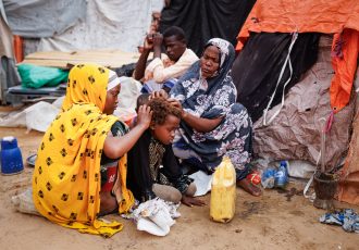 Khadijo Noor Ali (R) removes lice from the hair of eight year-old Dahiro Ibrahim Adan, at an IDP camp on the outskirts of Mogadishu, Somalia on Saturday December 17, 2022.